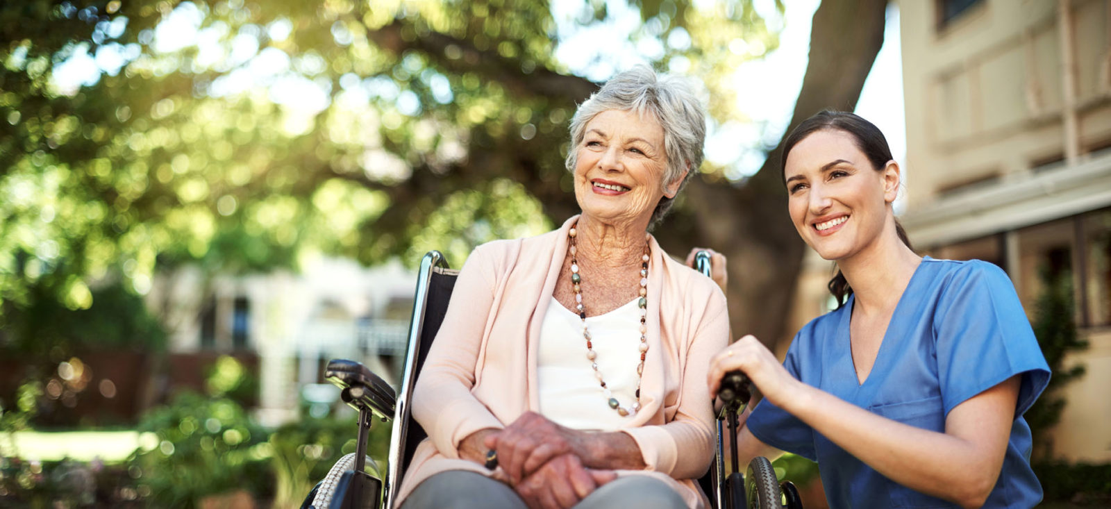 Shot of a young nurse spending time with a senior woman in a wheelchair in the garden