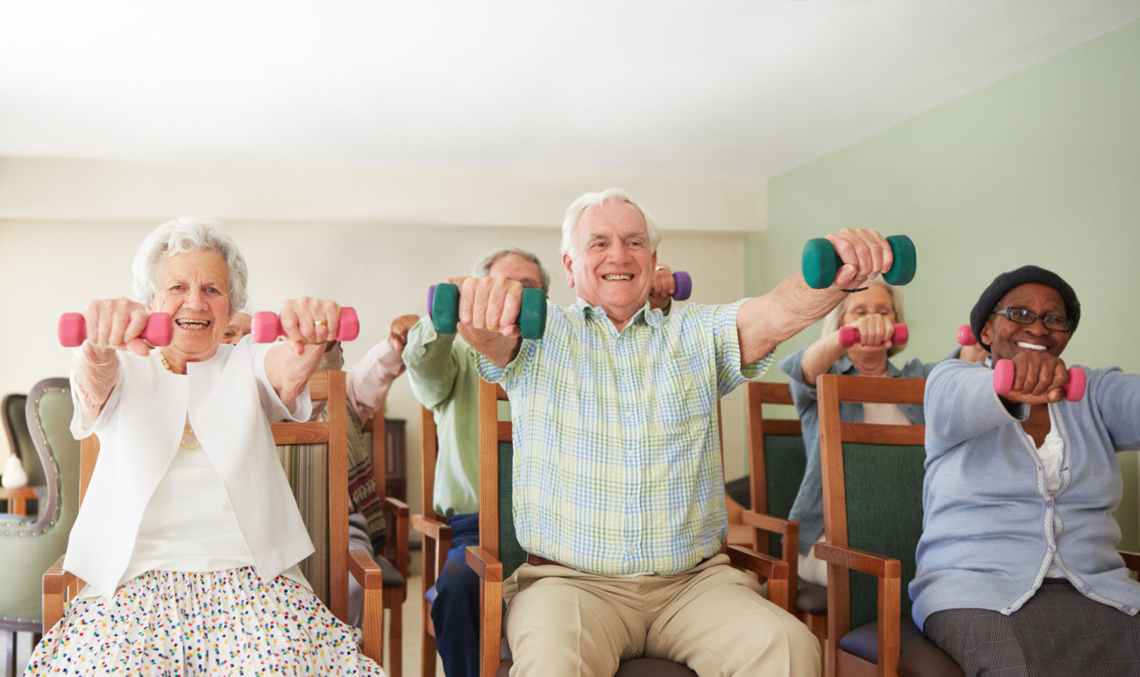 group of seniors exercising in chairs